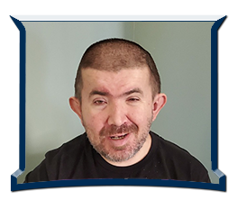 Adult man with short hair and facial hair smiling