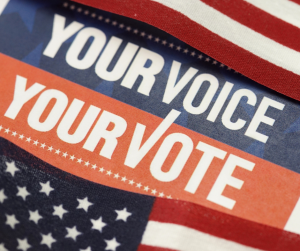 a message saying "Your voice, your vote" between two American flags